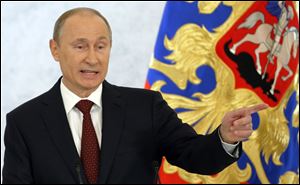 Russian President Vladimir Putin speaks during a state-of-the nation address in Moscow, Russia, today.