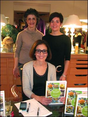 Olivia Summons, left, Meredith Sherman of Sophia Lustig Shop, right. Seated is Olivia's sister Cynthia Kallile of Chicago who was autographing her new cookbook. 