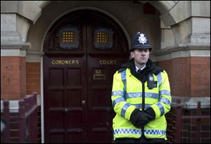 A policeman stands on duty outside Westminster Coroner's Court where the initial inquest into nurse Jacintha Saldanha's death is being opened, in London,Thursday.