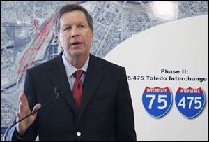 Ohio Gov. John Kasich discusses plans for the Ohio Turnpike, and future funding of Ohio highway projects, during a news conference at Modern Builders Supply in Toledo. 