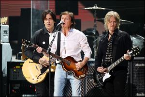 Paul McCartney, center, at the 12-12-12 The Concert for Sandy Relief at Madison Square Garden in New York on Wednesday. Proceeds from the show will be distributed through the Robin Hood Foundation. (AP Photo/Starpix, Dave Allocca)