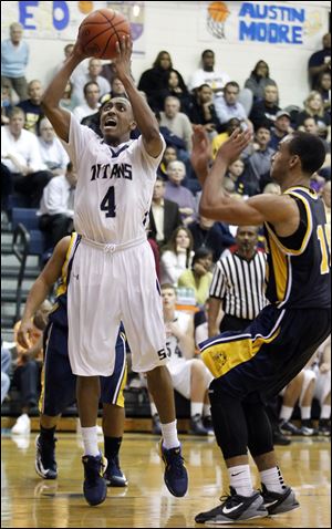 Anthony Glover of St. John's goes to the basket against Whitmer's Ricardo Smith in Wednesday night's game.