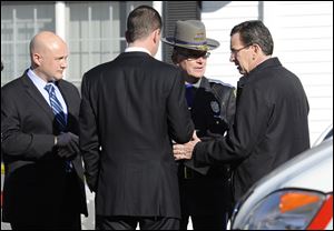 Gov. Dannel P. Malloy, right, talks with officials at a staging area following a shooting at the Sandy Hook Elementary School in Newtown, Conn., about 60 miles northeast of New York City.