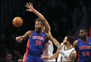 Detroit Pistons center Greg Monroe (10) loses the ball after a drive against Brooklyn Nets guard Deron Williams (8).