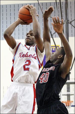 Scott's Chris Harris, who had 34 points, tries to steal the ball from Bowsher's junior Jason Sandridge.