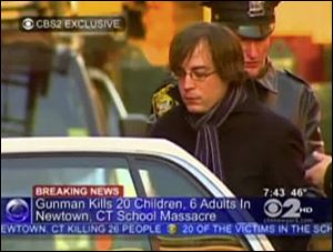 Ryan Lanza, the 24-year-old brother of Sandy Hook Elementary School shooter Adam Lanza, is escorted by police into a cruiser in Hoboken, N.J.