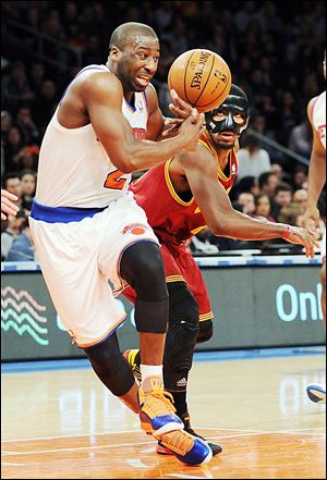 New York Knicks guard Raymond Felton, left, loses the ball as Cleveland point guard Kyrie Irving defends Saturday at Madison Square Garden in New York.