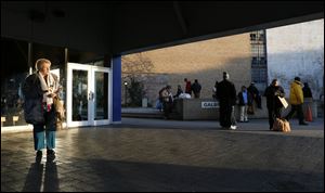 Late-afternoon sunlight streams through the bus plaza at Erie Street and Madison Avenue downtown. Temperatures Friday rose into the 40s.