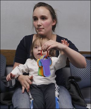 Lindsay Heffner, 21, with her son Evan Rice, 10 months, says she disagrees with part of a bill that would require drug testing for those on public aid.