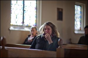 Mary Fellows of Newtown, Conn., weeps while waiting for a prayer service to begin at St John's Episcopal Church on Saturday in Newtown.  