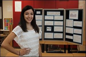 Sylvania Southview junior Jasmine Serpen pauses in front of the diagram that became a paper published in the November issue of the peer-reviewed journal Food and Nutrition Sciences. 