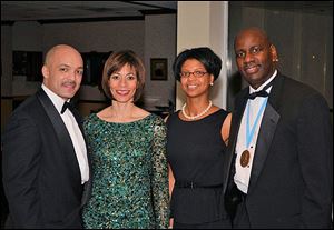 Pariss Coleman and his wife Dr. Traci Watkins, with Kelly Winston and her husband Boule president Thomas Winston at the Alpha Phi Boule Christmas party at Bradywine Country Club.
