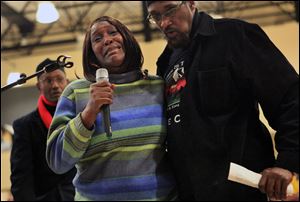 Martha Williams sobs as she asks for answers in the death of her daughter, Malissa, at a community meeting about the shooting deaths of Malissa Williams and Timothy Russell, Friday, in East Cleveland.