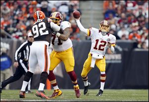 Washington Redskins quarterback Kirk Cousins passes against the Cleveland Browns in the second quarter of an NFL football game in Cleveland.