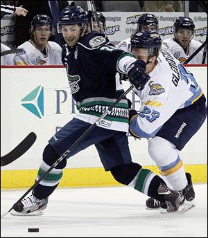 Toledo's Luke Glendening, right, and Florida Everblades' Matt Beca fight for the puck at the Huntington Center.
