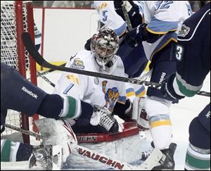 Walleye goalie Jordan Pearce is surrounded by  Florida players during Sunday's game at Huntington Center in downtown Toledo.