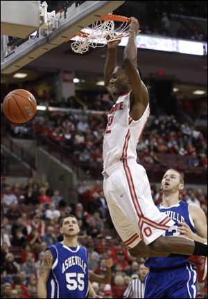 Ohio State's Sam Thompson dunks the ball in front of UNC-Asheville's Trent Meyer, left, and D.J. Cunningham during the first half on Saturday.