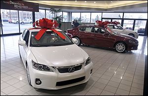 Cars at the Jim White Lexus dealership on Central Avenue sport the bows that the automaker supplies at Christmas time.