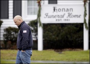 A mourner leaves a funeral service today for Sandy Hook Elementary School shooting victim, Jack Pinto, 6, in Newtown, Conn. 