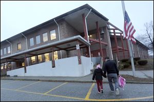 Manuel Moreno, right, walks his daughter Jady, 6, to the Morris Street elementary school in Danbury, Conn. 