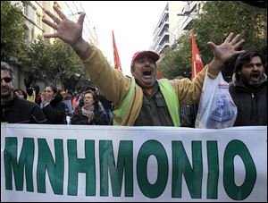 Striking Greek municipal employees chant slogans during a protest outside at the northern port city of Thessaloniki, Greece as a banner reads in Greek 