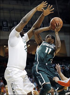 Michigan State's Keith Appling shoots over Miami's Reggie Johnson. The junior leads the Spartans at 15.5 points per game.