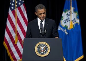 President Obama pauses during a speech at Newtown High School Sunday. 