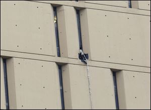 A rope dangles from a window on the back side of the Metropolitan Correctional Center in Chicago.