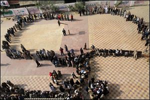 Egyptians wait in line to cast their votes during a referendum on a disputed constitution drafted by Islamist supporters of President Morsi in Cairo, Egypt, Saturday.