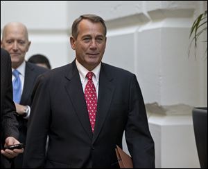 Speaker of the House John Boehner arrives for a closed-door meeting with House Republicans as he negotiates with President Obama to avert the fiscal cliff.