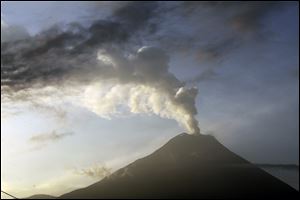 The Tungurahua volcano emits an an ash-filled plume as seen from Huambalo, Ecuador, Monday.