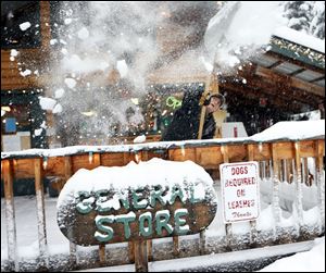 Don McLachlan shovels out from a winter snow storm at Shelter Cover Resort and Marina on Willamette Pass after a snow storm descended on the area on Monday.