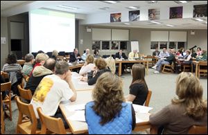 Dr. Michael Zalar, Superintendent, center at table gives a presentation to a crowded room on reconfiguring grades in the next school year during the Oregon school board's special meeting earlier this month at Clay High School.