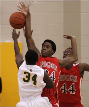 Start's David Cox has his shot blocked by Rogers' Tribune Dailey, Jr., during their City League game Tuesday night. Rogers, which averages 91 points per contest, won on the road.