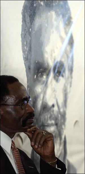 Rubin ‘Hurricane’ Carter, a former boxer who was found guilty of murder in 1967 but later released because the conviction was  racially motivated, waits to speak in St. Joseph, Mich. He said residents of nearby Benton Harbor need to be heard to stop the violence there. Mr. Carter also questioned the need for extra police, which he likened to an ‘occupation’ force.