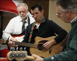 Left to right Marty Mohler, Tom Puffenberger, and John Rozic. Jingle Balls plays only two shows per year; The Toledo Municipal Court's Holiday Lunchtime Potluck held at the Toledo Municipal Court Auditorium on December 21 at noon and a fundraising gig at Mickey Finn's Pub at 8 pm the same day.
