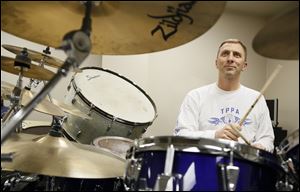 Toledo Municipal Court Judge Michael Goulding plays the drums in Jingle Balls. Some of its members are in bands of their own that regularly play in the area.  Others hit the stage only during the Christmas season. The band was formed in 2007.