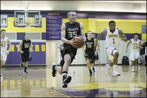 Perrysburg High School player Shane Edwards, 35, heads for the basket Thursday night at Maumee High School.
