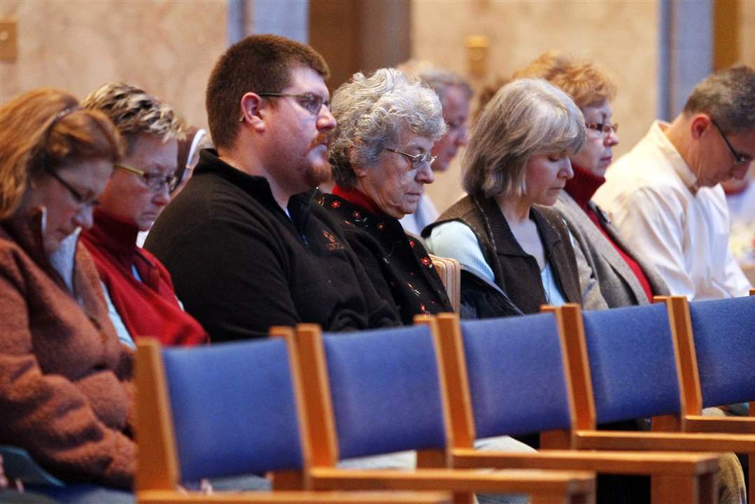 Participants-bow-their-heads-in-silence-during-a-memorial-service
