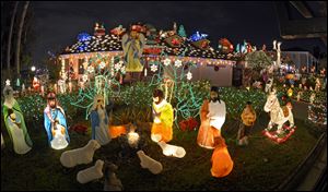 Christmas lights decorate a home in Los Angeles. Decorate away, rel estate experts advise sellers. However, owners should avoid going over-the-top with holiday decorations.