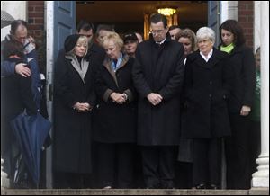 Connecticut Gov. Dan Malloy, center, stands with other officials to observe a moment of silence while bells ring 26 times in Newtown, Conn. today.