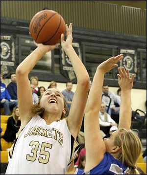 Perrysburg's Samantha Gremler gets a hand on the ball as Anthony Wayne's guard Abby Allen attempts to shoot.
