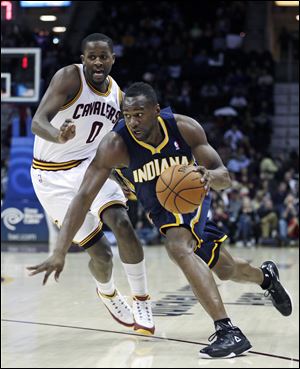 Indiana Pacers' Sam Young, right, drives past Cleveland Cavaliers' C.J. Miles.