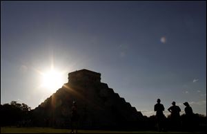People gather in front of the Kukulkan Pyramid in Chichen Itza, Mexico on Thursday.
