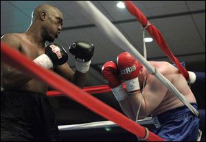 Tim Washington of Toledo pummels Alen Basic during their fight at the Grand Plaza Hotel on Friday night.