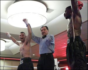 Mitchell Molina, left, Wauseon, celebrates his win over Anthony Kelly, of Toledo.
