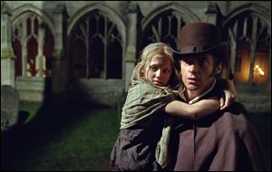 Hugh Jackman as Jean Valjean holding Isabelle Allen as Young Cosette in a scene from 