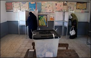 Egyptians cast their votes during the second round of a referendum on a disputed constitution drafted by Islamist supporters of President Mohammed Morsi in Fayoum, about 100 kilometers (62 miles) south of Cairo , Egypt, Saturday, Dec. 22, 2012.(AP Photo/Khalil Hamra)