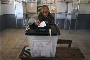 An Egyptian man casts his vote during the second round of a referendum on a disputed constitution drafted by Islamist supporters of President Mohammed Morsi in Fayoum, about 100 kilometers (62 miles) south of Cairo, Egypt, Saturday, Dec. 22, 2012.(AP Photo/Khalil Hamra)