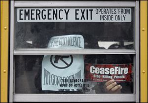 FILE - In this April 1, 2008 file photo, anti-gun literature is displayed in the window of a school bus leaving downtown Chicago after a rally to remember classmates killed by gun violence in the school year and a call for stiffer gun control measures. In the wake of the Dec. 14, 2012 mass shooting at Sandy Hook Elementary School in the small town of Newtown, Conn., there is now much political discussion about gun control. For urban advocates, this new emphasis on gun control is long overdue. (AP Photo/Charles Rex Arbogast, File)